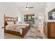 Comfortable main bedroom with wood floors, a ceiling fan, and natural light at 11103 E Blue Sky Dr, Scottsdale, AZ 85262