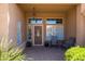 Inviting covered porch with tiled floor, seating area, and decorative hanging lantern at 11103 E Blue Sky Dr, Scottsdale, AZ 85262