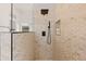 Modern shower with stylish tile, sleek fixtures, glass partition, and a convenient shower niche at 11103 E Blue Sky Dr, Scottsdale, AZ 85262