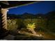Inviting back patio with an ornate pillar and beautiful desert landscape views at 11320 E Winchcomb Dr, Scottsdale, AZ 85255