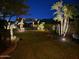 Beautiful backyard with lush landscaping, stone pathway, and inviting pergola perfect for entertaining at 11320 E Winchcomb Dr, Scottsdale, AZ 85255