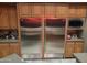 Gourmet kitchen featuring stainless steel appliances and custom wood cabinetry at 11320 E Winchcomb Dr, Scottsdale, AZ 85255
