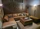 Cozy living room boasts a plush sectional sofa, warm lighting, and unique wall decor at 11320 E Winchcomb Dr, Scottsdale, AZ 85255