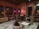 Stylish living room with a full bar, elegant decor, fireplace, and comfortable seating area at 11320 E Winchcomb Dr, Scottsdale, AZ 85255
