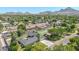 Expansive aerial view showcasing the home, pool, mature trees, and stunning mountain backdrop at 1208 E Tuckey Ln, Phoenix, AZ 85014