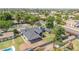 Wide aerial perspective featuring the home and surrounding neighborhood, lush greenery, and city skyline at 1208 E Tuckey Ln, Phoenix, AZ 85014