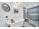 Stylish bathroom featuring a freestanding tub, glass-enclosed shower, and sleek modern design at 1208 E Tuckey Ln, Phoenix, AZ 85014