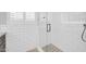 Bathroom shower with gray and white subway tiles and glass door at 1208 E Tuckey Ln, Phoenix, AZ 85014