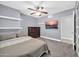 Cozy bedroom featuring wall-mounted TV, floating shelves, and a spacious dresser at 1208 E Tuckey Ln, Phoenix, AZ 85014