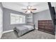 Cozy bedroom with mounted shelves, gray walls, and TV on the wall at 1208 E Tuckey Ln, Phoenix, AZ 85014