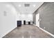 Spacious bonus room showcasing concrete floors, ample lighting, gray brick accent wall, and built-in desk with cabinets at 1208 E Tuckey Ln, Phoenix, AZ 85014