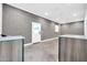 Versatile bonus room with smooth concrete flooring, ample lighting, brick accent wall, and cabinets for storage at 1208 E Tuckey Ln, Phoenix, AZ 85014