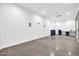 Large flex room featuring smooth concrete flooring, recessed lighting, built-in cabinets and pre-wired speaker outlets at 1208 E Tuckey Ln, Phoenix, AZ 85014
