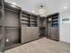 Spacious closet featuring custom shelving, drawers, and ample storage with stylish chandelier at 1208 E Tuckey Ln, Phoenix, AZ 85014