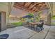 Inviting covered patio featuring a dining table, chairs, grill, and string lights for outdoor gatherings at 1208 E Tuckey Ln, Phoenix, AZ 85014