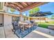 Relaxing outdoor area featuring a covered patio with dining table, seating, and view of the backyard at 1208 E Tuckey Ln, Phoenix, AZ 85014
