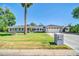 Charming single-Gathering home featuring lush front lawn, mature palm tree and two-car garage at 1208 E Tuckey Ln, Phoenix, AZ 85014