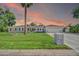 Charming single-Gathering home featuring lush front lawn, mature palm tree and two-car garage at 1208 E Tuckey Ln, Phoenix, AZ 85014