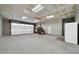 Large garage features storage and workbench areas, overhead doors, and ample lighting at 1208 E Tuckey Ln, Phoenix, AZ 85014