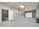 Finished garage with concrete floors and side door to the home at 1208 E Tuckey Ln, Phoenix, AZ 85014