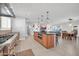 Open-concept kitchen with a central island, stainless steel appliances, and a view of the living spaces at 1208 E Tuckey Ln, Phoenix, AZ 85014