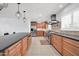 Spacious kitchen featuring wood cabinets, stainless steel appliances, and a large island with pendant lighting at 1208 E Tuckey Ln, Phoenix, AZ 85014