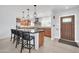 Well-lit kitchen featuring wood cabinets, stainless steel appliances, an island, and a welcoming entrance at 1208 E Tuckey Ln, Phoenix, AZ 85014