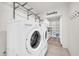Well-organized laundry room featuring modern washer and dryer, open shelving, and ample storage space at 1208 E Tuckey Ln, Phoenix, AZ 85014