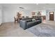 Open-concept living room with a dining area and kitchen featuring a neutral color palette and tile flooring at 1208 E Tuckey Ln, Phoenix, AZ 85014