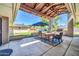 View of covered patio area with outdoor seating, grill, landscaping, and grass backyard at 1208 E Tuckey Ln, Phoenix, AZ 85014