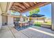 Covered patio area with outdoor seating, grill, landscaping, and access to the house at 1208 E Tuckey Ln, Phoenix, AZ 85014