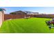 Manicured backyard with artificial turf and a seating area at 12204 W Parkway Ln, Avondale, AZ 85323
