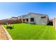 Spacious backyard with artificial turf, patio and a seating area at 12204 W Parkway Ln, Avondale, AZ 85323