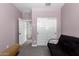 Light purple bedroom with a futon and sliding door closet at 12204 W Parkway Ln, Avondale, AZ 85323