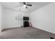 Clean bedroom with carpet flooring, a ceiling fan, and large windows at 12204 W Parkway Ln, Avondale, AZ 85323