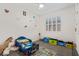 Bright bedroom featuring a blue toddler bed, playful decor, and a ceiling fan at 12204 W Parkway Ln, Avondale, AZ 85323