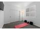 Bedroom with light gray carpet, white walls, closet with sliding doors, and a floor lamp at 12204 W Parkway Ln, Avondale, AZ 85323