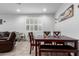 Bright dining area with wood-look flooring and an adjacent window with plantation shutters, ideal for casual meals and entertaining at 12204 W Parkway Ln, Avondale, AZ 85323