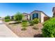 Charming single-story home with landscaped desert front yard and shutters, perfect for curb appeal and low-maintenance living at 12204 W Parkway Ln, Avondale, AZ 85323