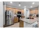 Well-lit kitchen featuring stainless steel appliances, granite countertops, and wood cabinets at 12204 W Parkway Ln, Avondale, AZ 85323
