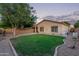 Beautiful backyard featuring a lush green lawn, stone landscaping, and a view of the home's exterior at 14864 W Riviera Dr, Surprise, AZ 85379
