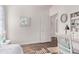 Neutral bedroom with a study desk, a decorative painting and white trim at 14864 W Riviera Dr, Surprise, AZ 85379