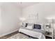 Well-lit bedroom featuring a stylish rug and two decorative white bedside tables with lamps at 14864 W Riviera Dr, Surprise, AZ 85379