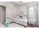 Bright bedroom showcasing blue accents, a plush rug, and a comfortable daybed near the window at 14864 W Riviera Dr, Surprise, AZ 85379