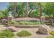 Rancho Gabriela entrance sign with stone pillars, desert landscaping, and gravel ground cover at 14864 W Riviera Dr, Surprise, AZ 85379