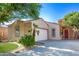 Well-maintained single-Gathering home featuring desert landscaping, a driveway, and inviting entry for lasting curb appeal at 14864 W Riviera Dr, Surprise, AZ 85379