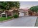 Single-story home with desert landscaping, driveway, and covered entryway, blending charm and functionality at 14864 W Riviera Dr, Surprise, AZ 85379