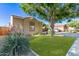A well-manicured front yard leads to the home, complemented by mature landscaping and a welcoming atmosphere at 14864 W Riviera Dr, Surprise, AZ 85379