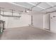 Spacious garage featuring concrete floors, overhead storage racks, and an automatic door opener at 14864 W Riviera Dr, Surprise, AZ 85379