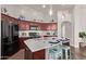 Bright kitchen with cherry cabinets, white countertops, subway tile backsplash and stainless-steel appliances at 14864 W Riviera Dr, Surprise, AZ 85379
